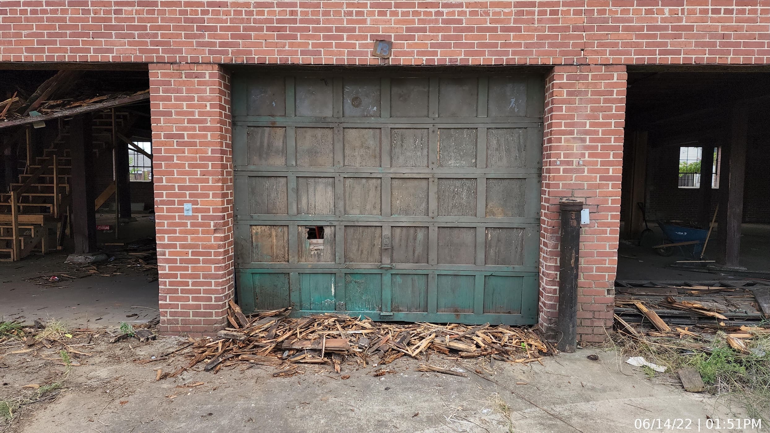 Existing wood, sectional, paneled doors. In order to comply with the historic requirements, the door/window assemblies egressing each unit were required to match this configuration.