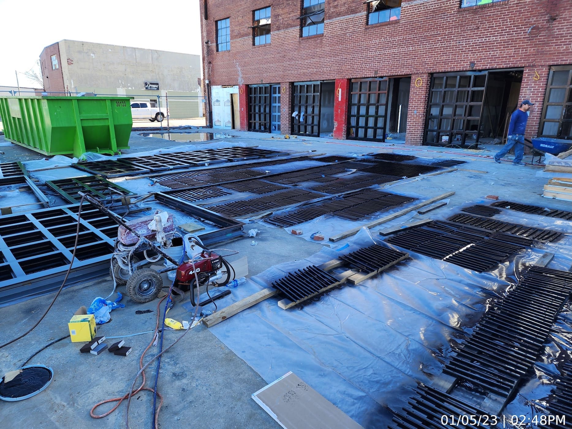 A portion of the door/window assemblies installed. Other units being primed and painted before installation.