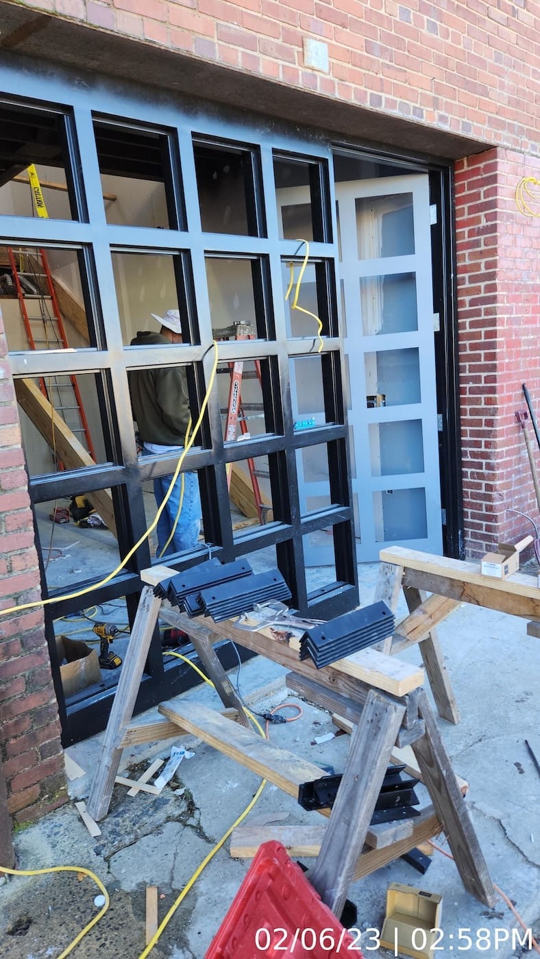 Door/window units installed. Glazing in progress.