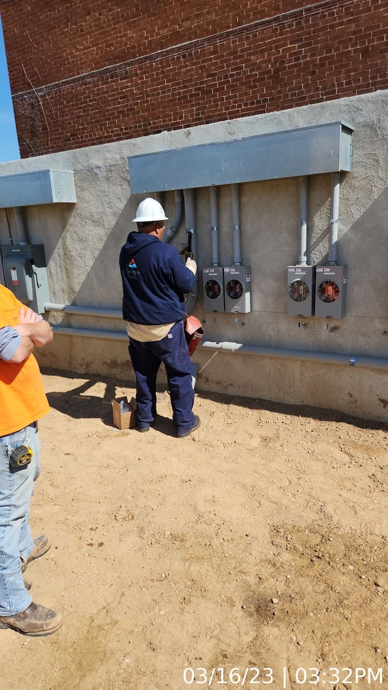 Installation of meter bases and custom-designed service at purpose-built masonry wall.