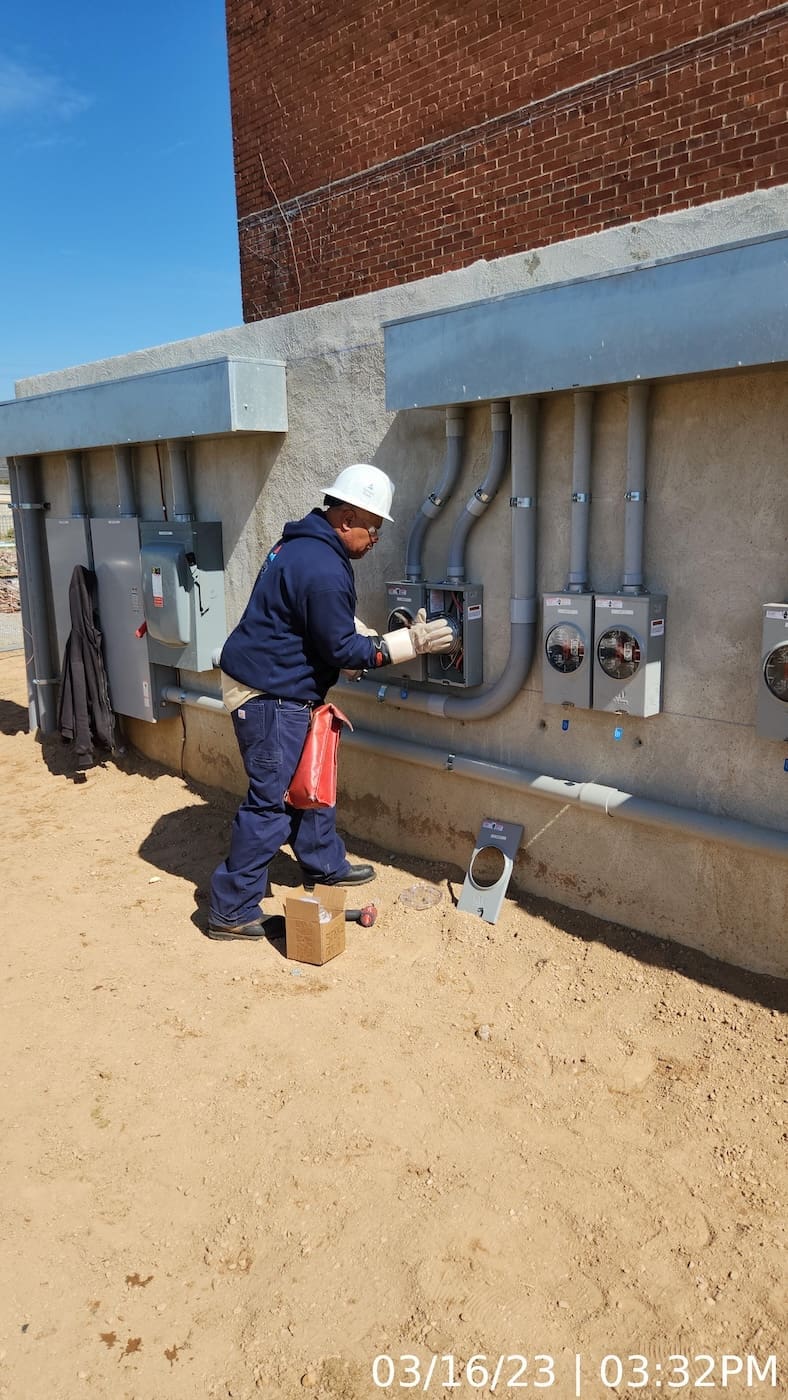 Installation of meter bases and custom-designed service at purpose-built masonry wall.