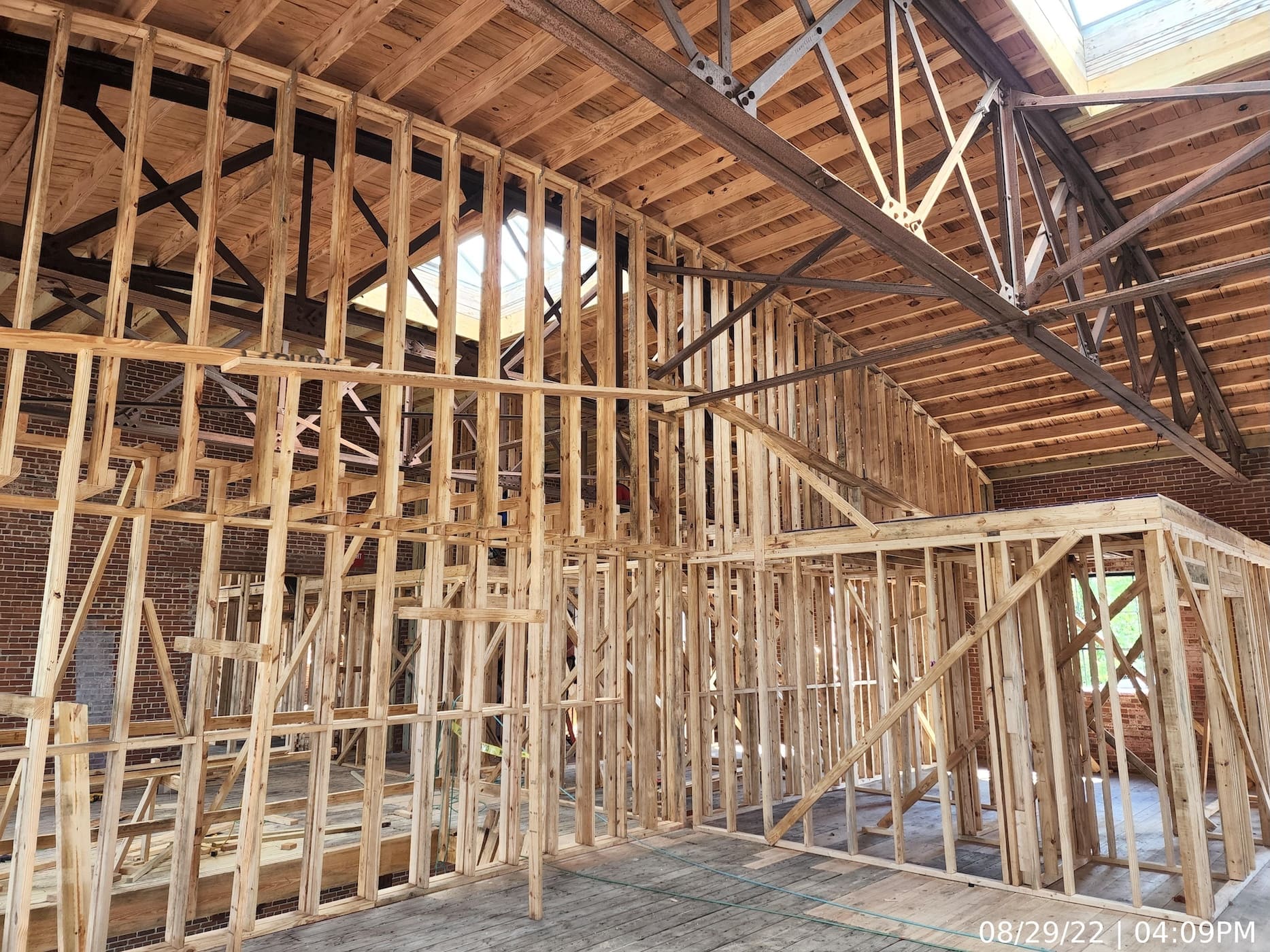 Upper level interior framing of fire-rated demising walls.