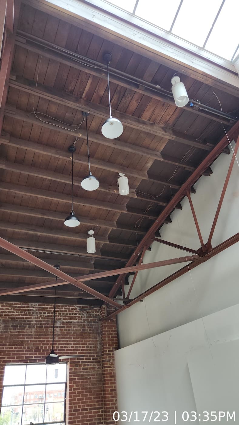 Painting contractor “graining” finish coat applied to intumescent paint to meet Historic Preservation requirements.