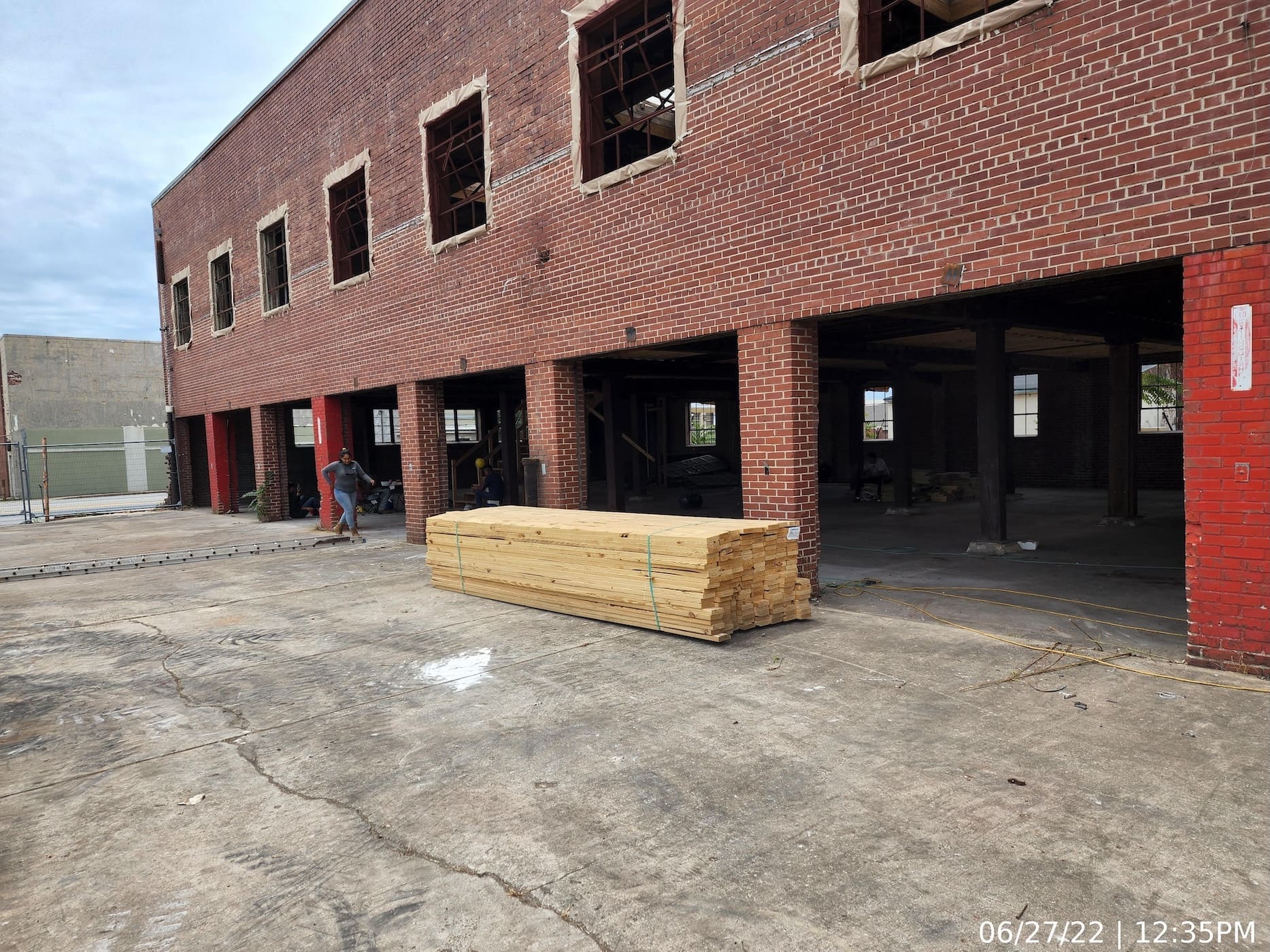 Front elevation showing door openings after removal of the existing wood-paneled sectional roll-up doors.