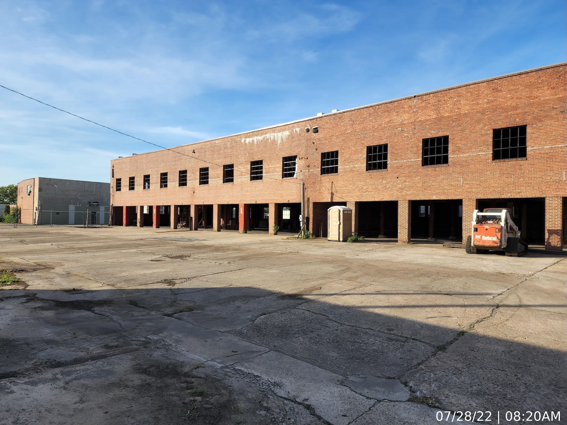 Front elevation showing door openings after removal of the existing wood-paneled sectional roll-up doors.